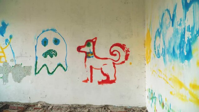 Drawings on the walls in a destroyed, abandoned and burned kindergarten building.