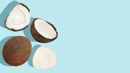 Coconut Background. Scattered coconuts and pieces of coconut on a blue background.