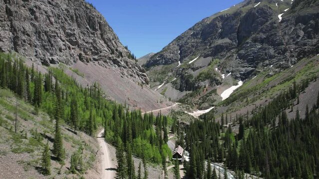 Flying Through Valley Toward Animas Forks Colorado 4K features an aerial drone view flying north through a mountain pass near Animas Forks Colorado.