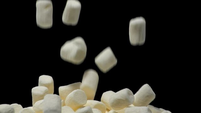 Pile of soft marshmallows falling. Sweet marshmallow falls from top to bottom.
