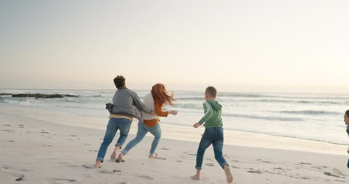Parents, playing and beach with children for fun on weekend with happiness with freedom or bond. Family, kid and running with ocean for quality time with energy for outdoor activity for travel.