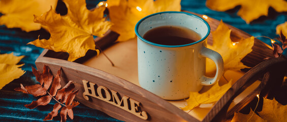 Cup Warm Coffee and Yellow Autumn Leaves by the Window. Fall Season and Home Cozy Concept. Vintage style.