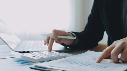 Businessmen are calculating income-expenditure and analyzing real estate investment data, Accounting Financial and tax systems concept.