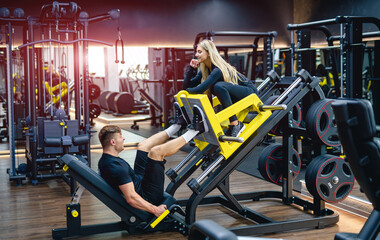 Lifestyle fitness couple. Training couple in modern gym.