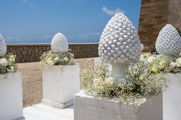 Flowers and ceramic pine cone arrangements, symbols of Sicily, wedding decoration
