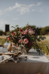 outdoor wedding decoration. Table setting with flowers.