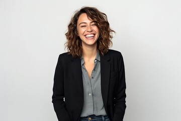 Portrait of a happy young business woman laughing and looking at camera - obrazy, fototapety, plakaty