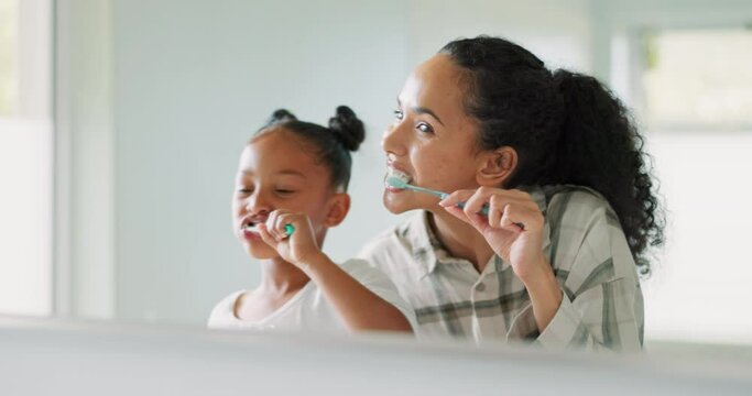 Brushing Teeth, Mother And Daughter In Mirror, Bathroom And Cleaning Mouth For Wellness, Health And Self Care. Mom, Girl Child And Toothbrush In Family House With Oral Hygiene, Smile And Teaching