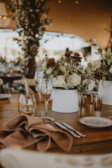 table setting with cup of wine, candles and flowers in a wedding