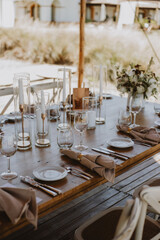 table setting with cup of wine, candles and flowers in a wedding