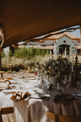 table setting with cup of wine, candles and flowers in a wedding