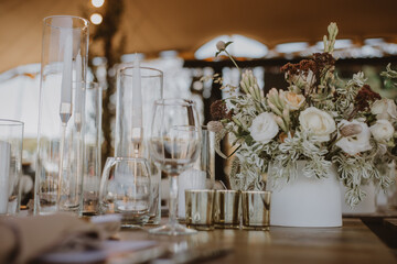 table setting with cup of wine, candles and flowers in a wedding