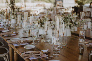 table setting with cup of wine, candles and flowers in a wedding
