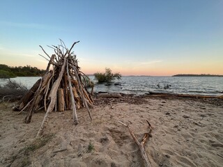 driftwood teepee on beach © Stouthouse Design
