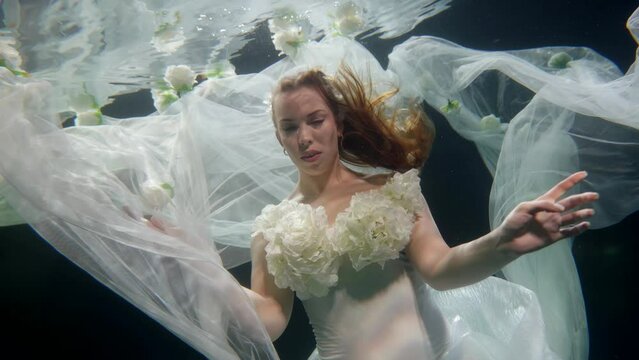 attractive woman underwater, romantic dream and fantasy, lady in wedding dress inside sea