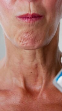 Woman Using Nicotine Gum To Quit Smoking