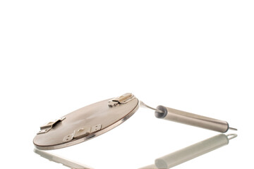 One metal adapter with handle for induction surface, macro, isolated on white background.