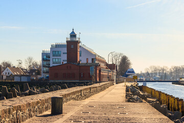 Old brick lighthouse at the Wieprza river mouth to the Baltic Sea in Darlowko, Poland