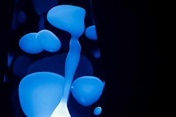 Close Up blue Lava Lamp, black background, horizontal format with copy space