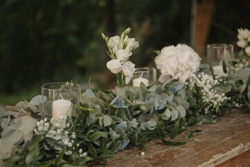 white flowers in a vase as table setting on a wedding