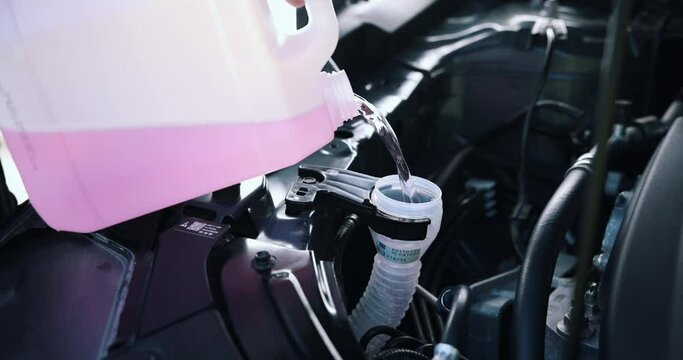 filling the tank of car windshield washer fluid
