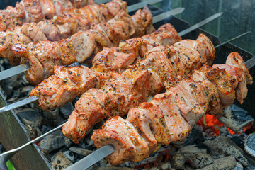 Pork skewers, roasted on skewers on the grill. Shashlik meat shish kebab on the grill. traditional outdoor barbecue picnic.