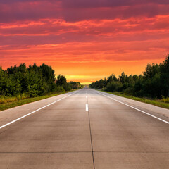 Empty highway in countryside at sunset