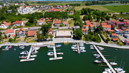 Panoramic aerial photo from drone to Mikolajki townscape - capital of Masurian region on the shore of the holiday resort beautiful summer afternoon. Mikolajki, Mikołajki, Poland, Europe.