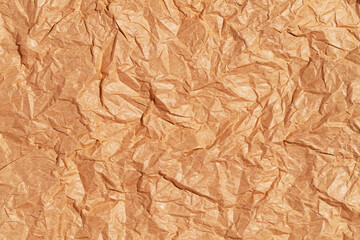 Crumpled blank sheet of brown wrapping kraft paper, vintage texture for the designer. Background of crumpled blank sheet 