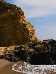 Fototapeta na wymiar Rocks on the beach against the sea on a sunny day 