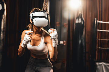 Female boxer training with VR or virtual reality, wearing VR headset with immersive boxing training technique using controller to enhance her skill in boxing simulator. Impetus