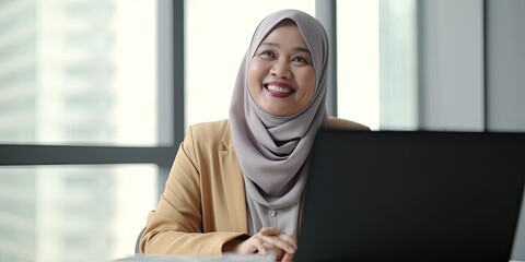 Smiling happy  BIPOC businessman executive CEO in a business suit and Hijab using a computer to work with a client in an office setting -room for copy text, generative AI 

