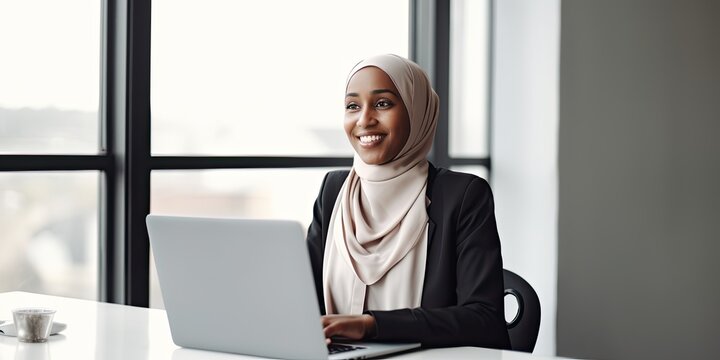 Smiling happy  BIPOC businessman executive CEO in a business suit and Hijab using a computer to work with a client in an office setting -room for copy text, generative AI 

