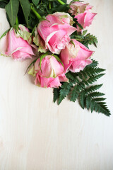 pink roses on wooden background