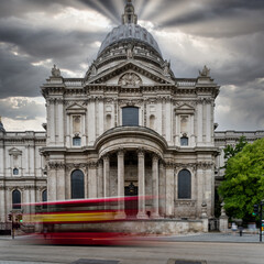 Long exposure red bus in capital against church