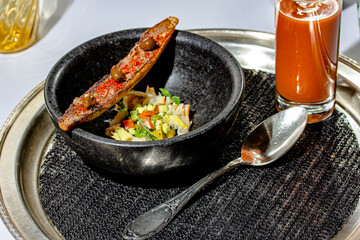 Fresh, healthy tomato soup with basil, pepper, garlic, tomatoes and bread on wooden background. Spanish gazpacho soup