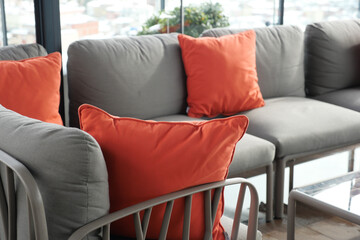 modern grey sofa with pillows in living room at home