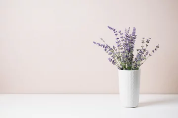Tuinposter Bouquet of lavender in a small vase, minimal still life. © Nataliia Sirobaba