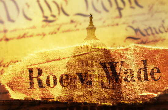 Roe v Wade newspaper headline with US Constitution and the US Capitol in Washington DC