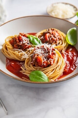 Vegetarian spaghetti Bolognese with Lentils in Tomato Sauce with Parmesan Cheese and Basil leaves. Healthy vegan food concept