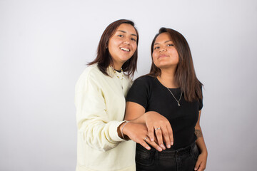 photograph of a female couple on a light photographic studio background.