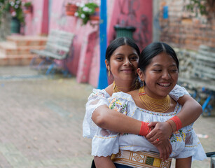 Fototapeta copyspace of two friends with traditional dresses in a park in latin america very happy obraz