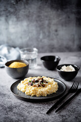 Corn porridge with fried bacon, parsley and Feta cheese in a bowl
