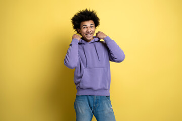 Portrait of smiling African American man posing for photo isolated on yellow background