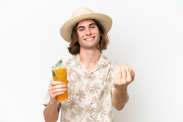 Young handsome man holding a cocktail isolated on white background inviting to come with hand. Happy that you came