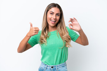 Young Uruguayan woman isolated on white background showing ok sign and thumb up gesture