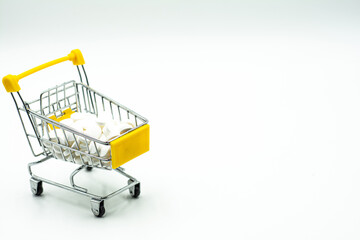 Mini shopping cart with pills and tablets isolated on white background. Shopping cart full of pills isolated on white. Shopping cart wit.