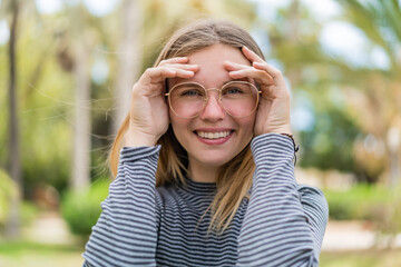 Young blonde woman with glasses at outdoors . Portrait