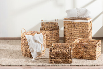 bathroom items that include baskets, towels and toiletries on a rug