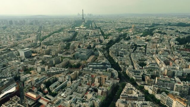 The cityscape of Paris involving the Eiffel Tower and La Defense business district as seen from the Maine-Montparnasse Tower